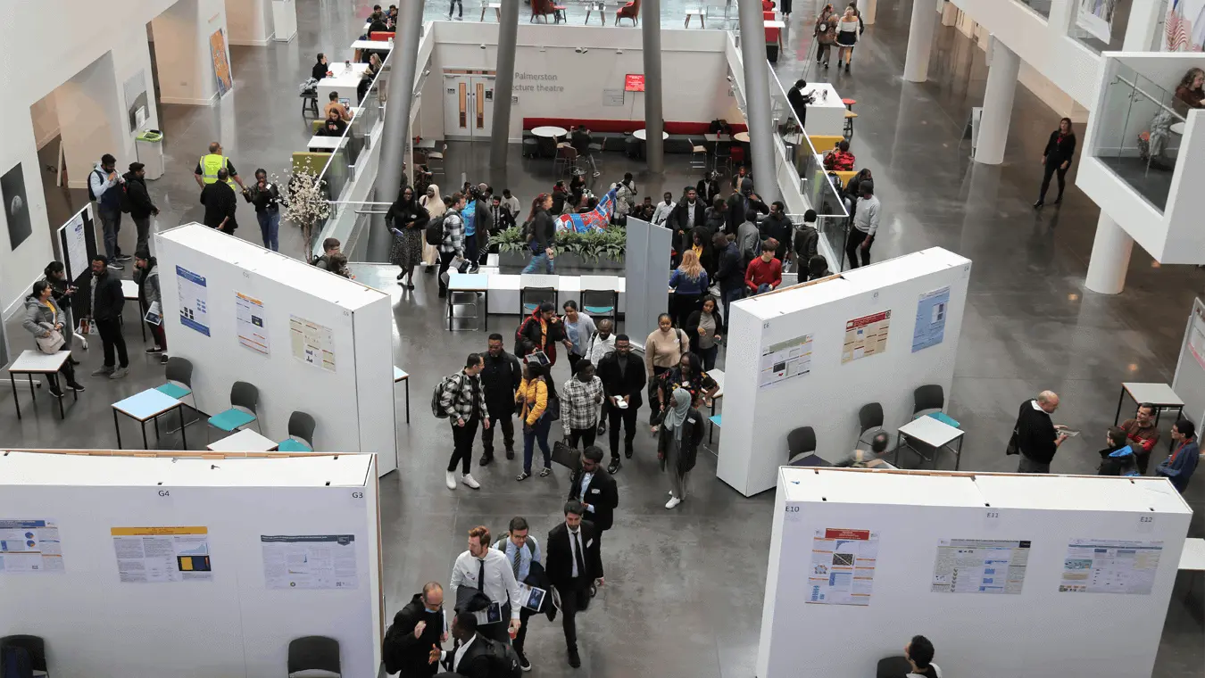 An exhibition and groups of students in the Spark atrium