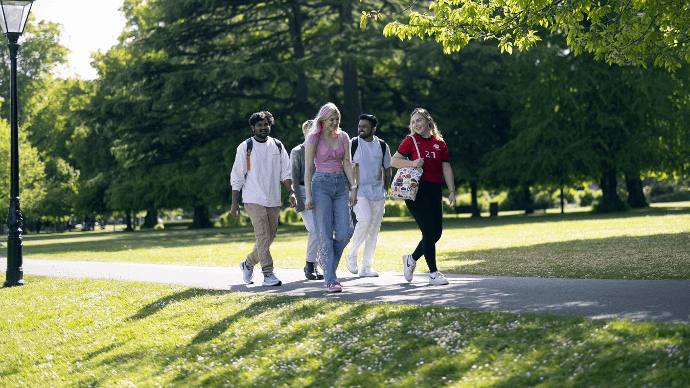 A group of students walking through the park