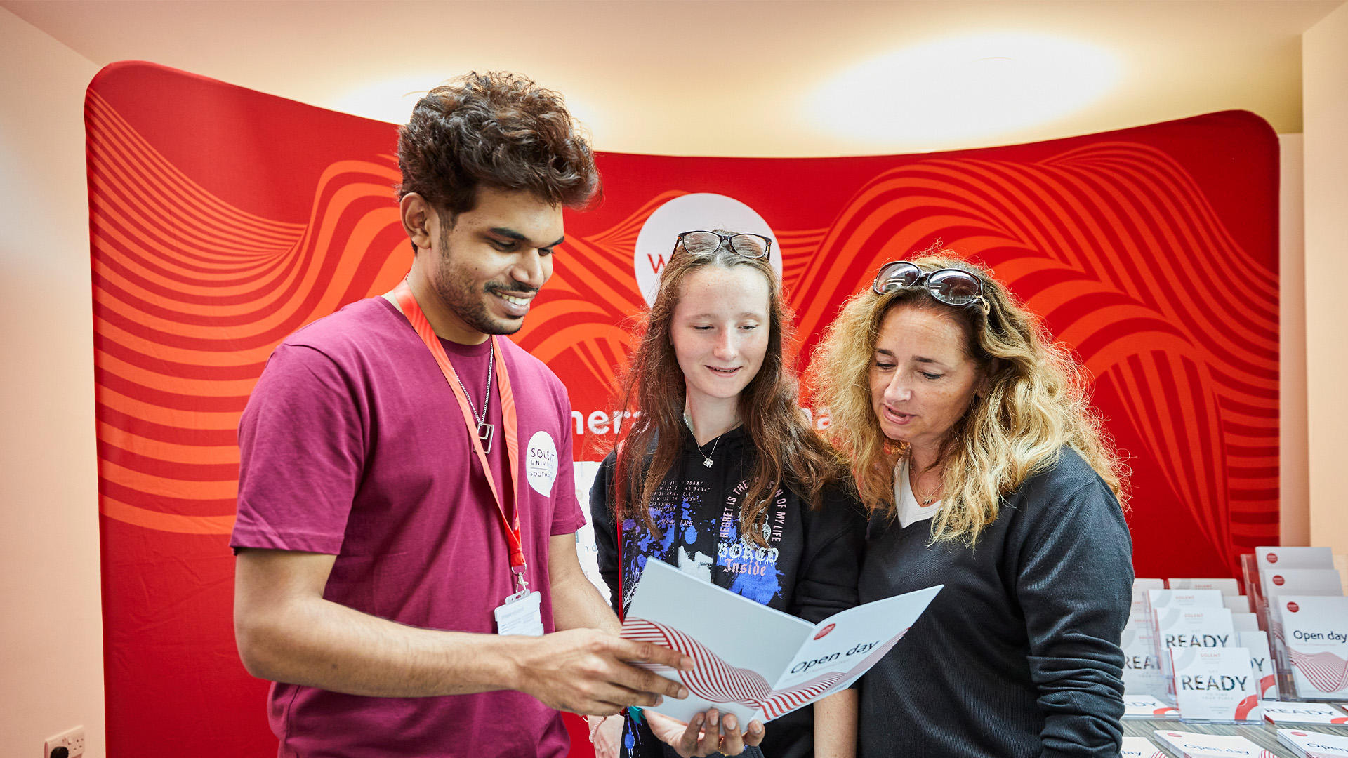 Image shows student ambassador chatting to guests on an open day