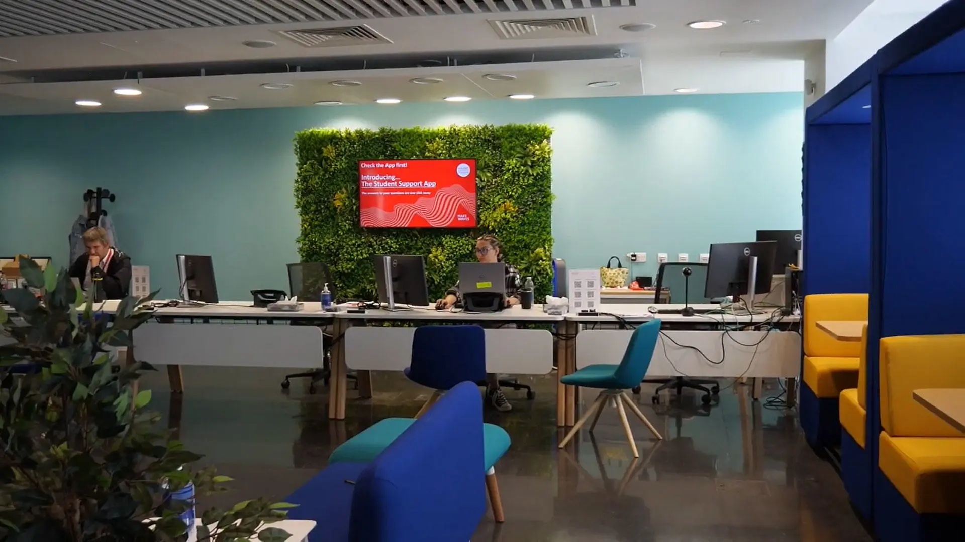 Inside the Student Hub with some of the team sat at their desks