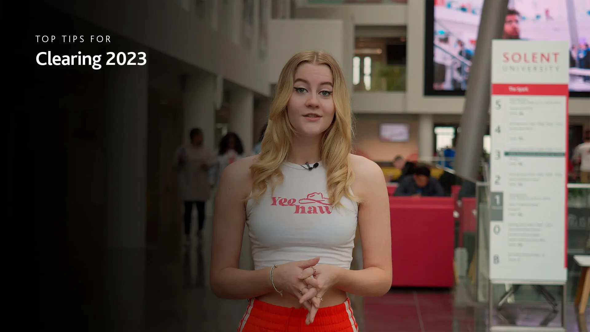 Student Katie talking to camera in our Spark building atrium. Text reads 'Top tips for Clearing 2023'