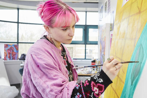 A female art student working on a painting