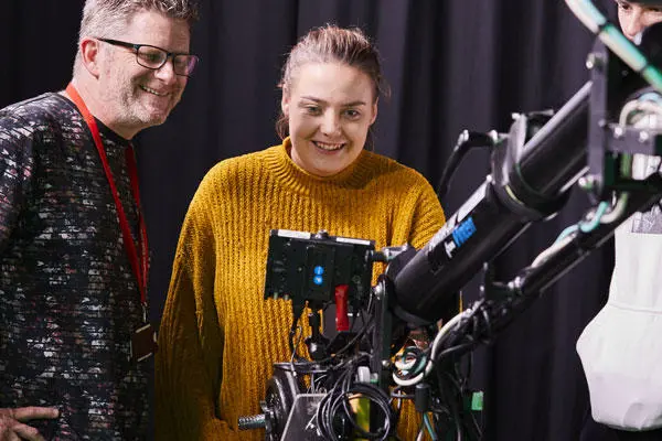 A media foundation year student looking at a camera