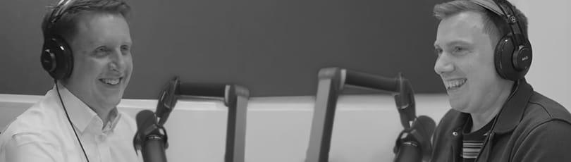 Solent lecturers wearing headphones and talking into a microphone