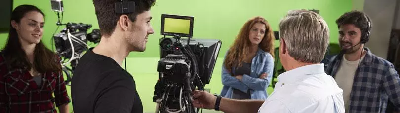 A group of students in a television studio with a camera