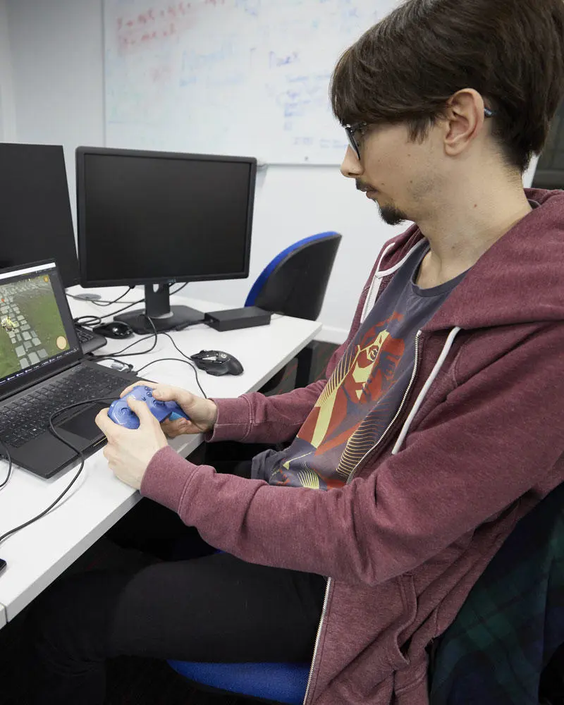 A digital arts students working on a project on a laptop
