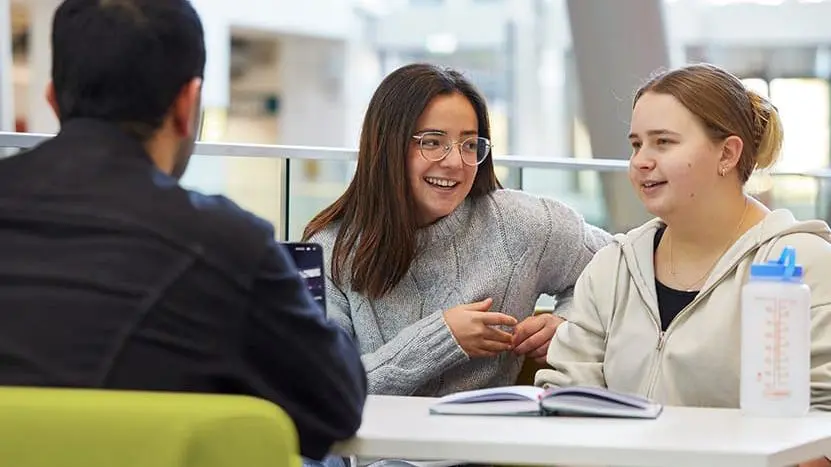 Students talking in the Spark building