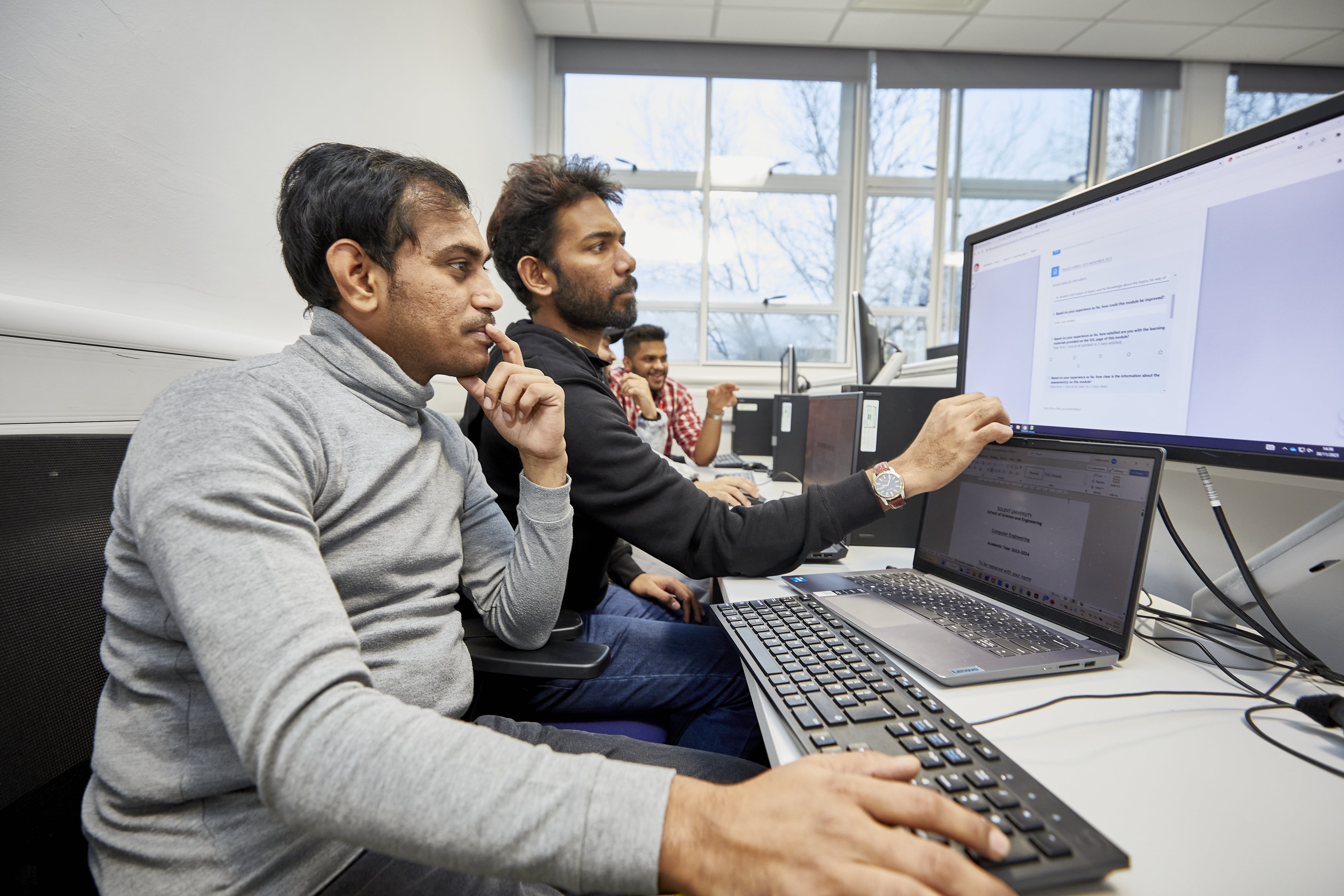Two people working at a computer