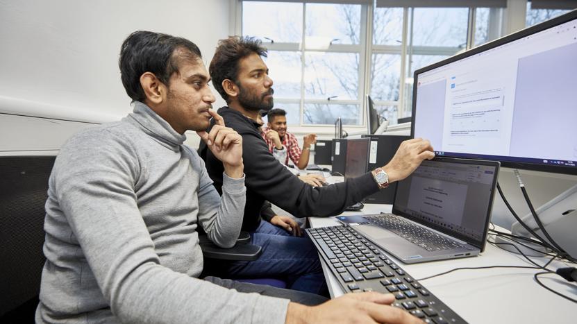 Two people working at a computer