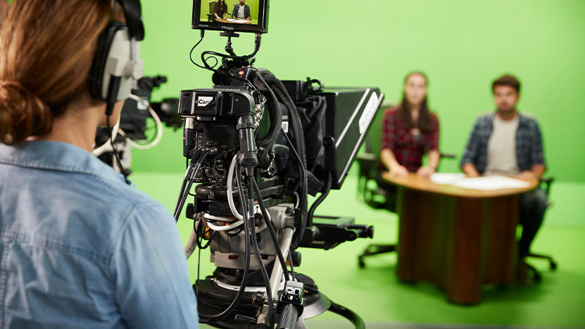 People working in a broadcast TV studio