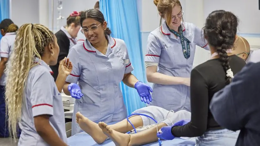Health professionals working in a nursing simulation suite