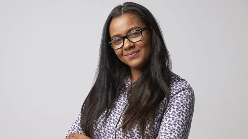 A female wearing glasses looking directly at the camera