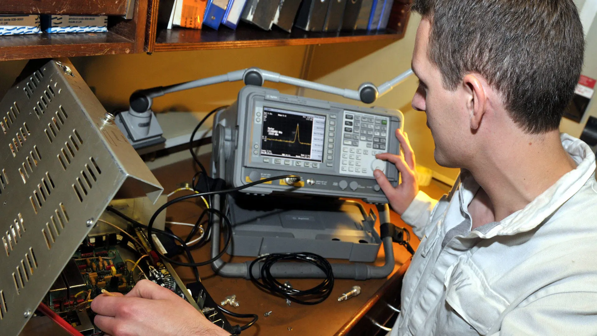 A marine electro-technical engineer working on radio equipment
