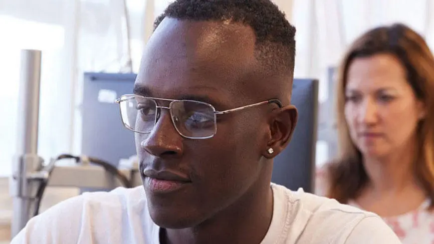 A male student wearing glasses