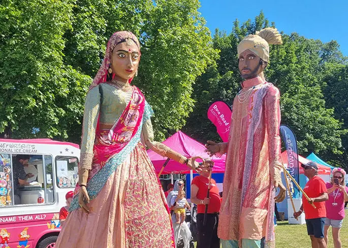 Three female students walking through the park