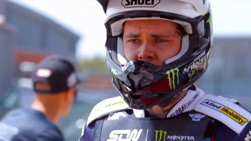 A speedway rider wearing a crash helmet