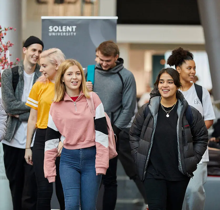 A group of students walking through the Spark