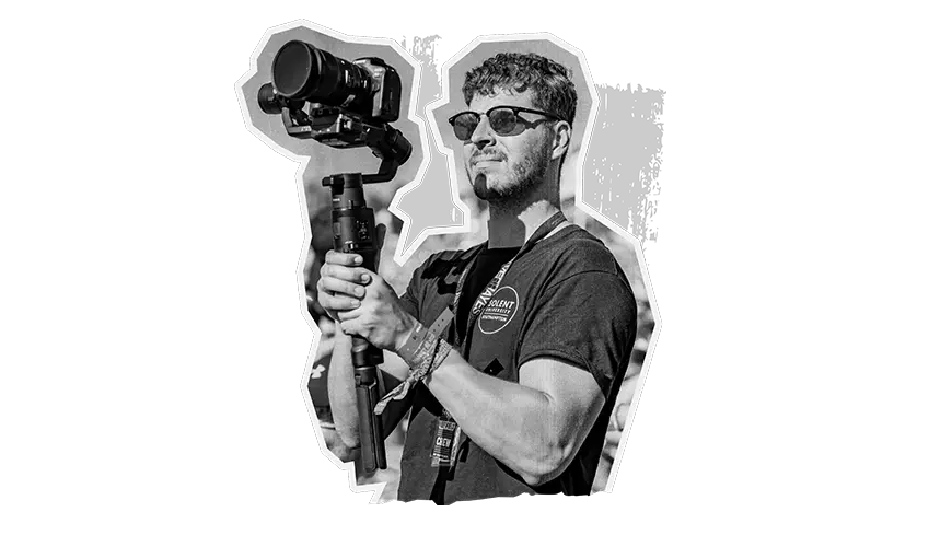 Black and white image of a person holding a video camera
