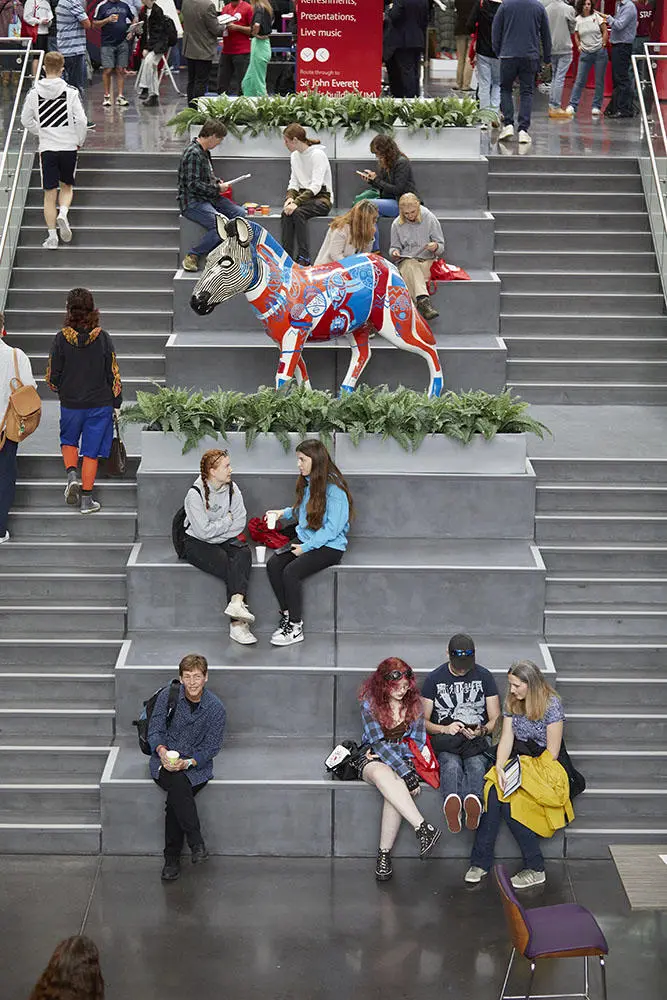 Students sat on the stairs in the Spark building