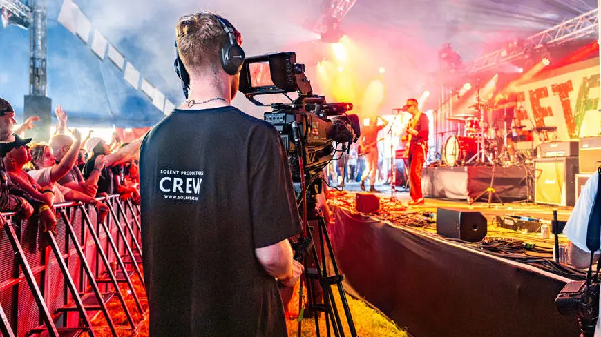 A Solent Productions student filming at a festival