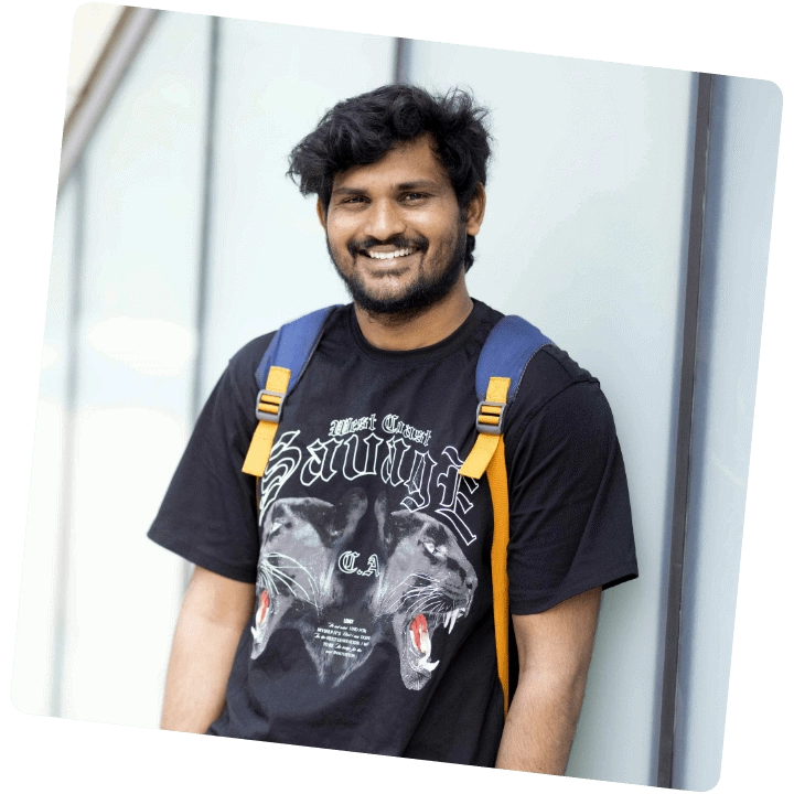 A male student smiling at the camera
