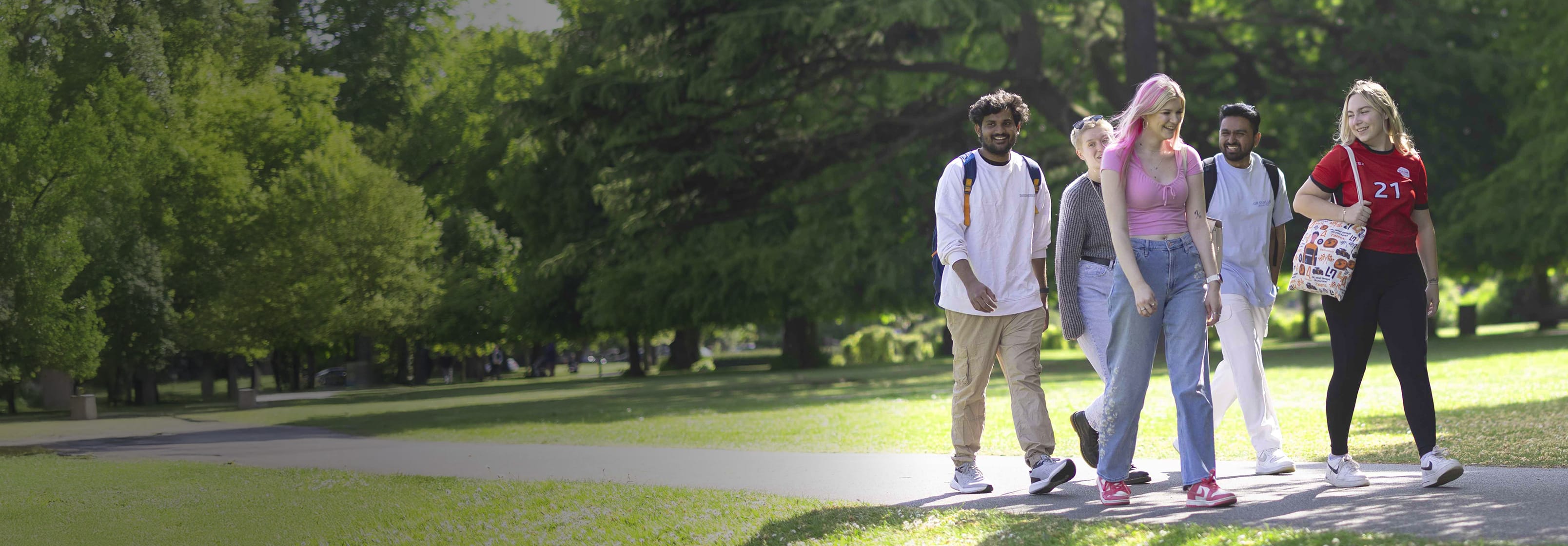 Solent University students walking through a park