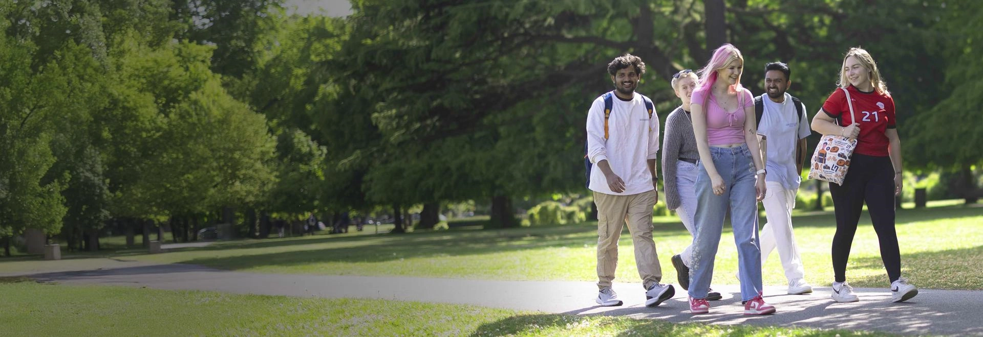 Solent University students walking through a park