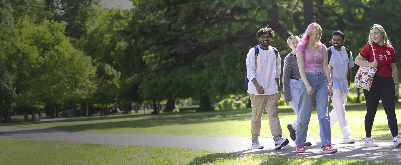 Solent University students walking through a park