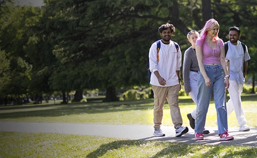 Solent University students walking through a park