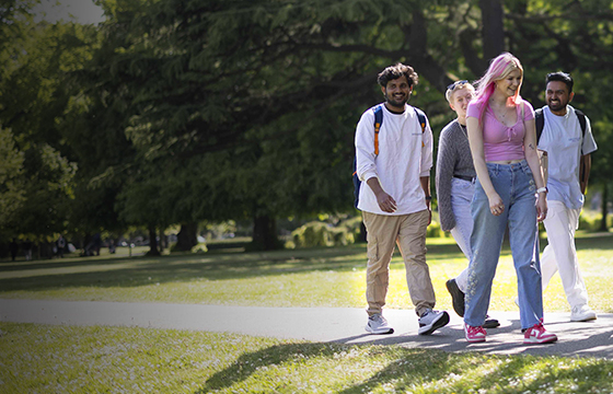 Solent University students walking through a park
