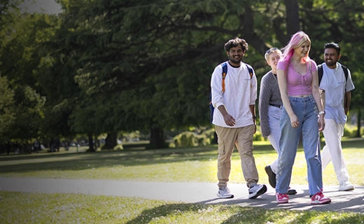 Solent University students walking through a park