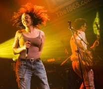 A female vocalist dancing on stage