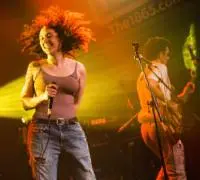 A female vocalist dancing on stage