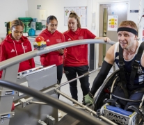 Three students with a client in the sport science laboratory