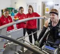 Three students with a client in the sport science laboratory