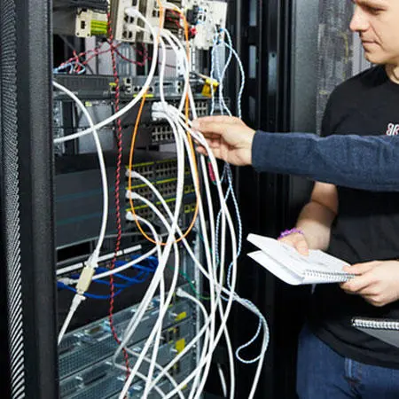People looking at network cables in a server system