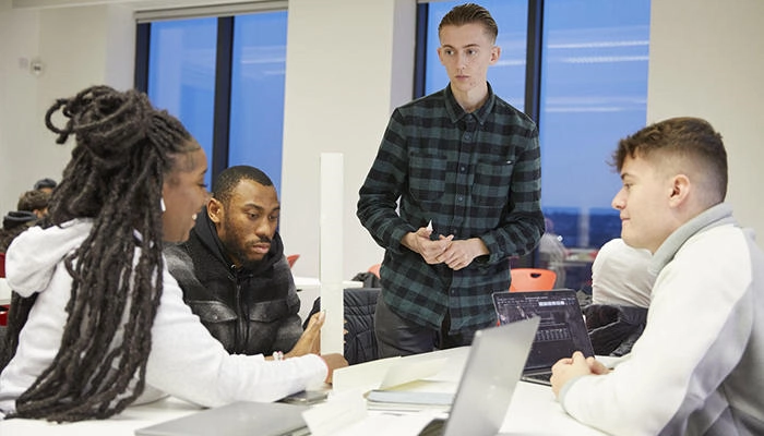 Four students working on a project