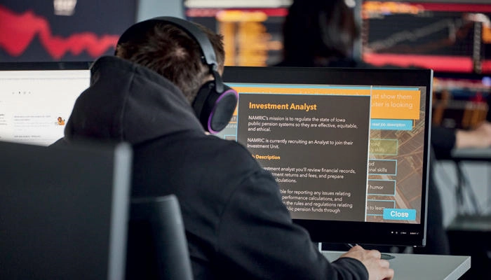A student looking at financial information on a computer monitor