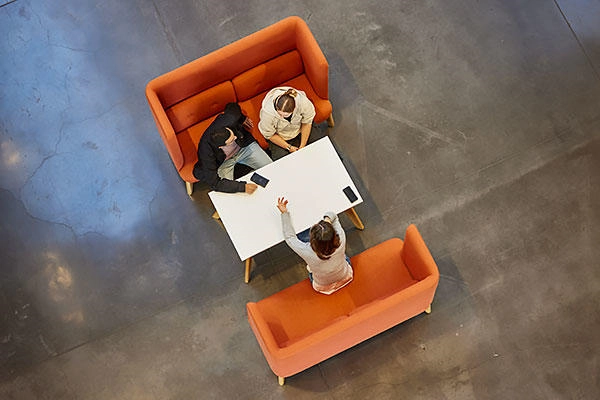 Overhead shot of people sitting on sofas around a table
