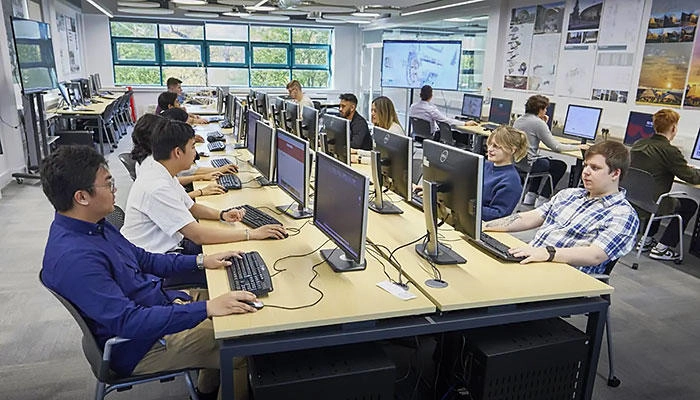 Architecture students working on computers in the architecture studio