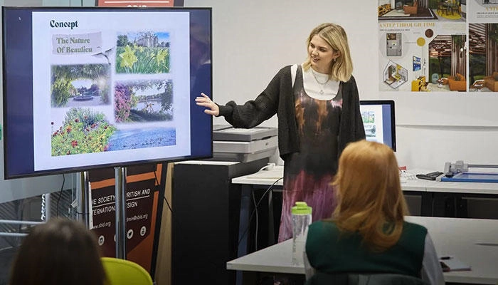 An interior design student presenting her work