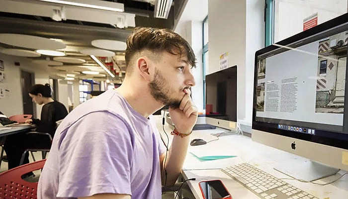 A digital design student working on a mac computer