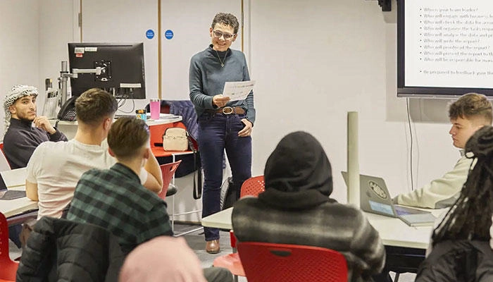 Students in a lecture with an academic