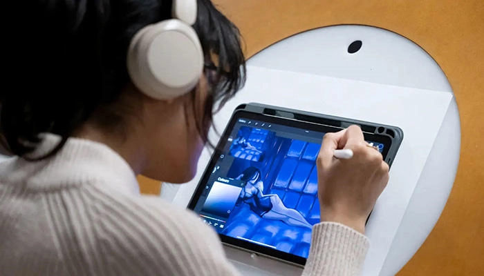 A computer games art student working in the studio