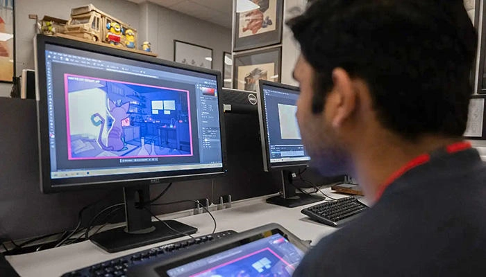 A digital arts student working in the studio