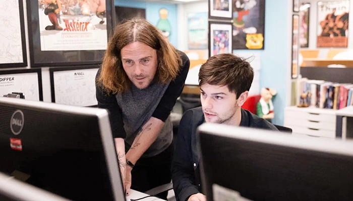 A digital arts lecturer with a student