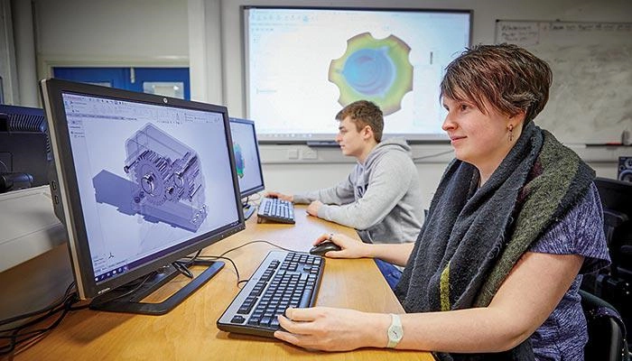 Engineering students working on a computer program