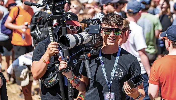 A Solent film and tv student with a camera at a festival