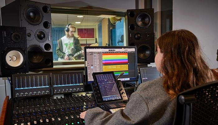 A music production student in the studio