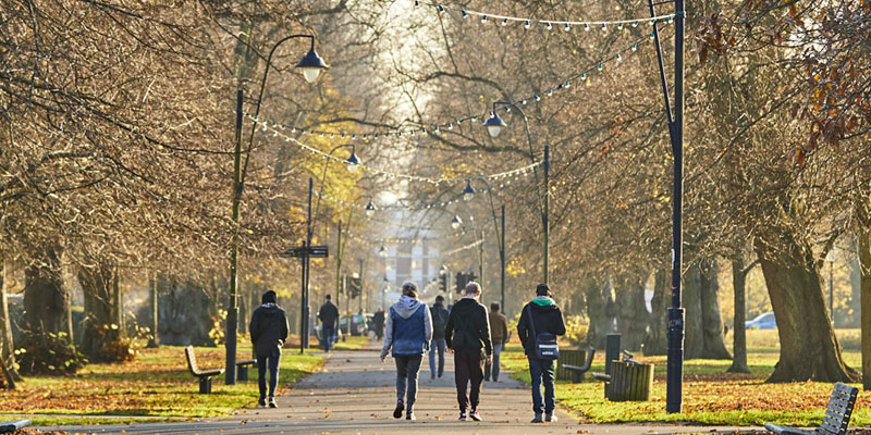 People walking through East Park in autumn
